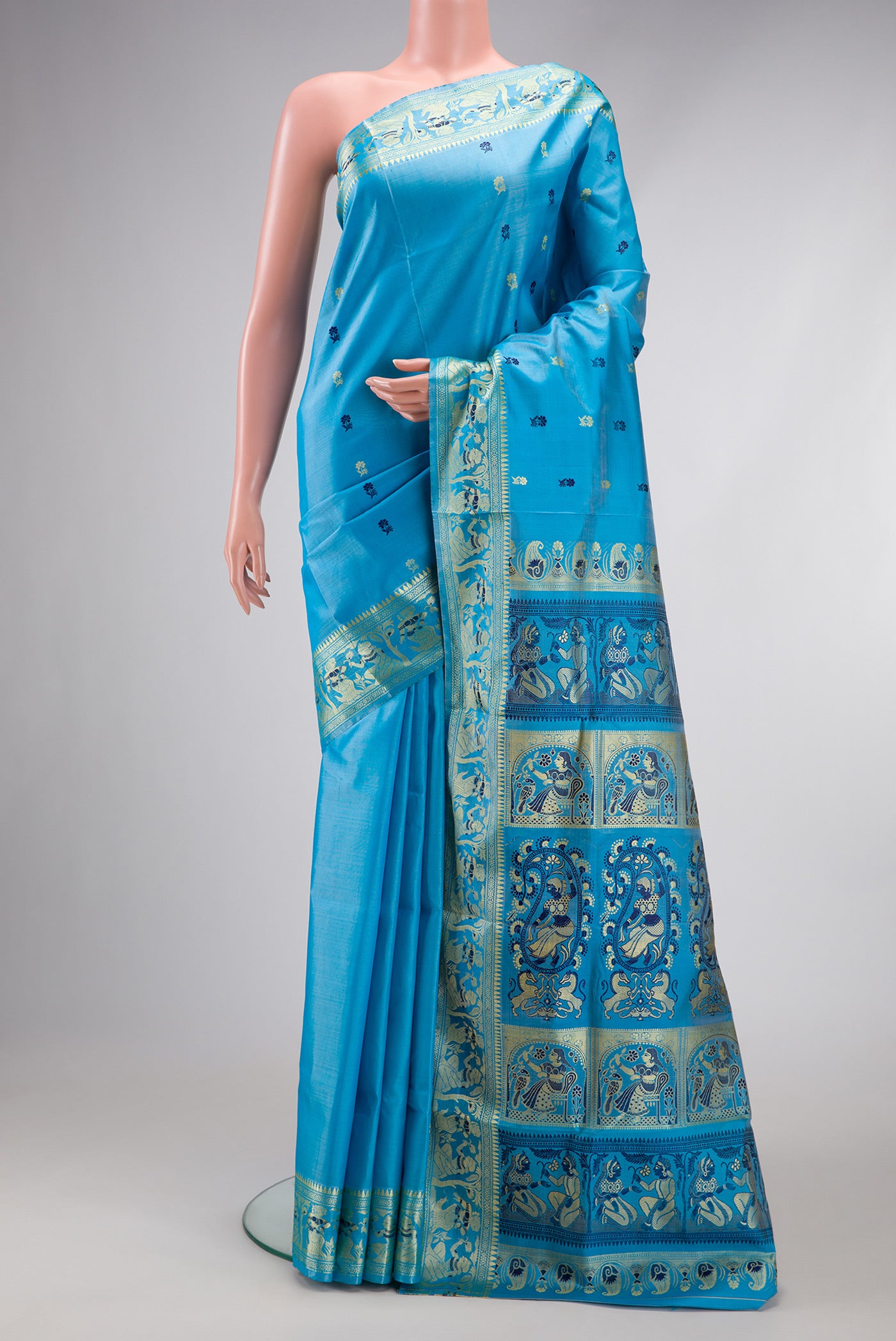Sky Blue Dual Tone Baluchari Silk Saree with Thread Butta on the body and Thread Border.  displayed on a mannequin