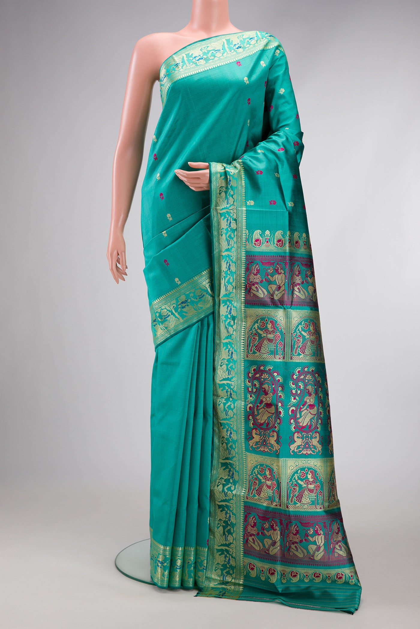 Turquoise Baluchari Silk Saree with Thread Butta on the body and Thread Border.  displayed on a mannequin