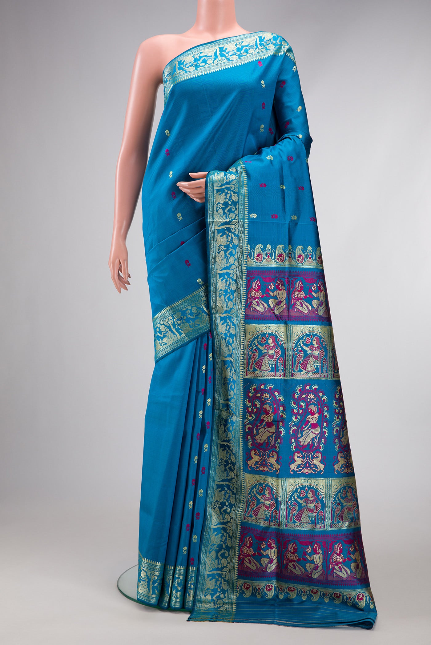 Sky Blue Baluchari Silk Saree with Thread Butta on the body and Thread Border.  displayed on a mannequin
