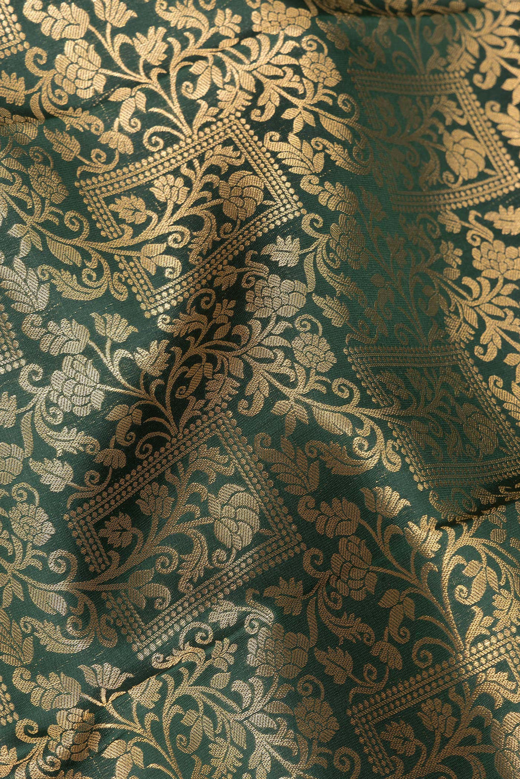 Close up of Pure Silk Bottle Green Kanjivaram Saree with Zari Brocade on the body and Zari Border.  displaying folds
