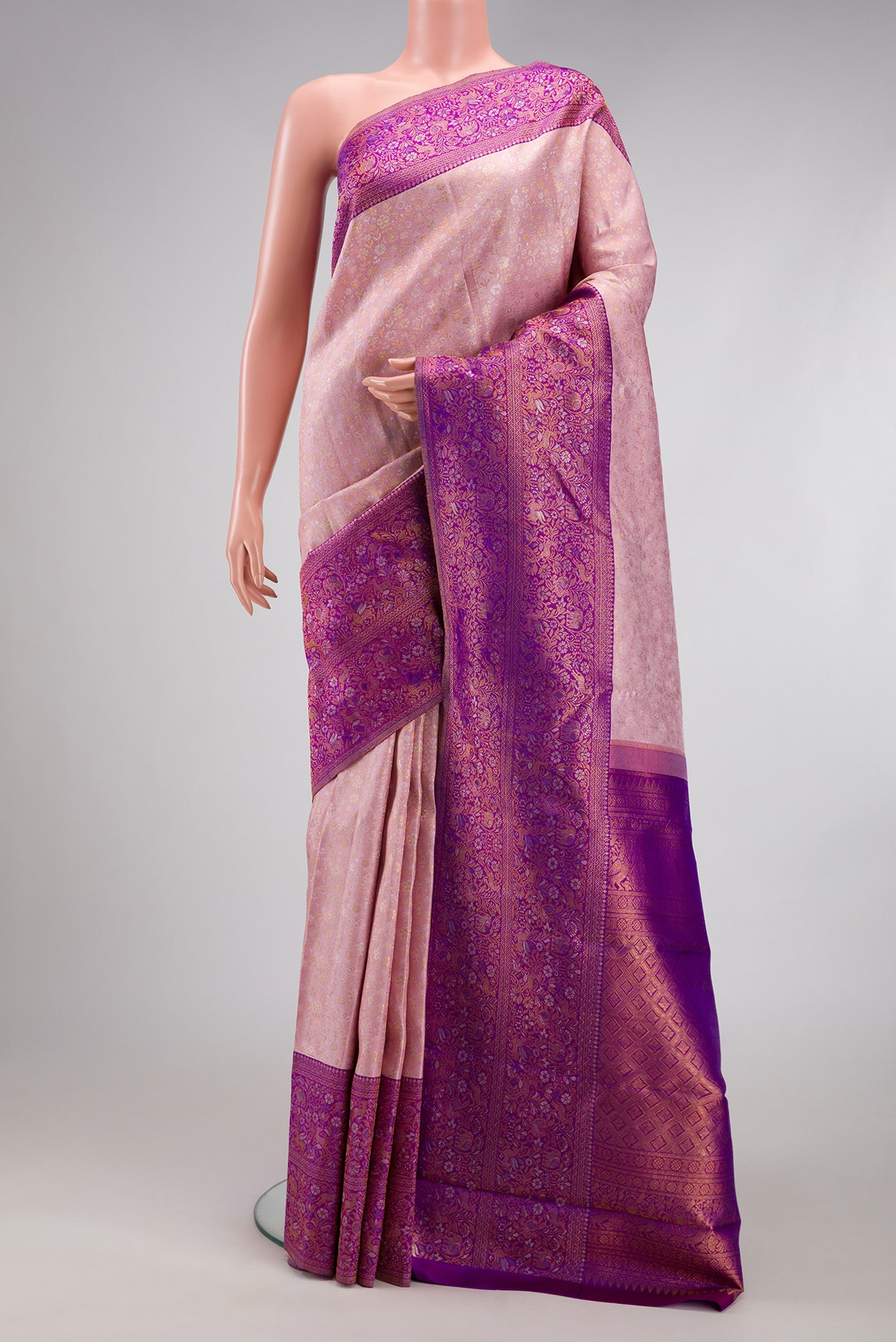 Rose Gold Kanjivaram Silk Saree with Zari Brocade on the body and Fancy Border.  displayed on a mannequin