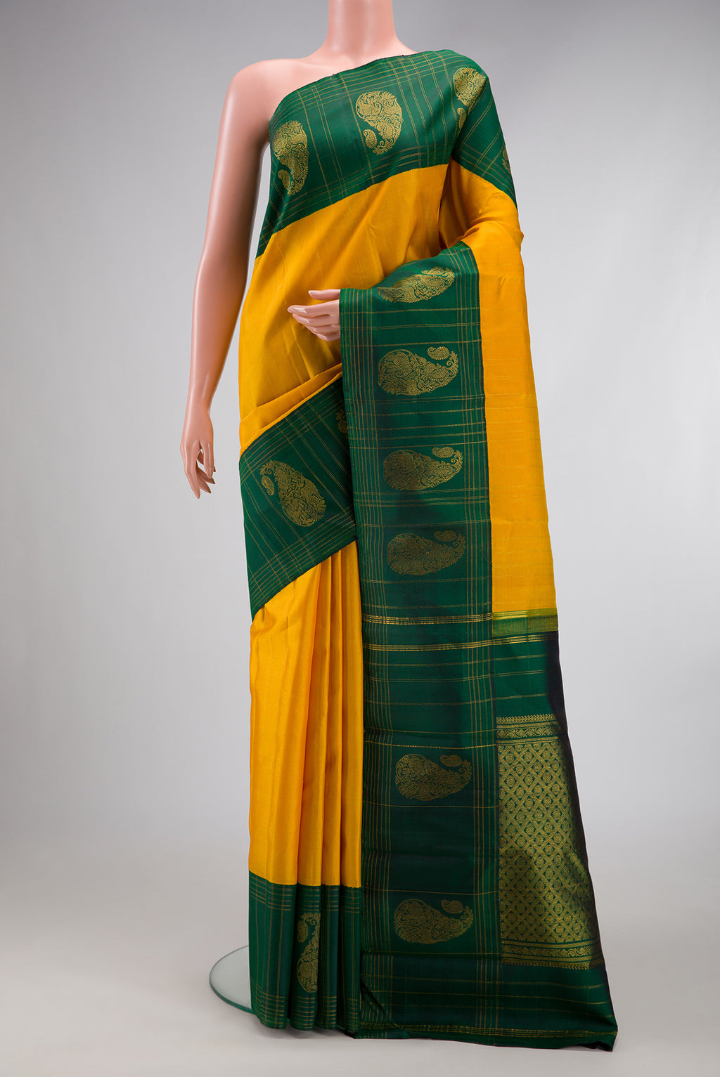 Yellow Kanchipuram Silk Saree with Stripes on the body and Fancy Border.  displayed on a mannequin