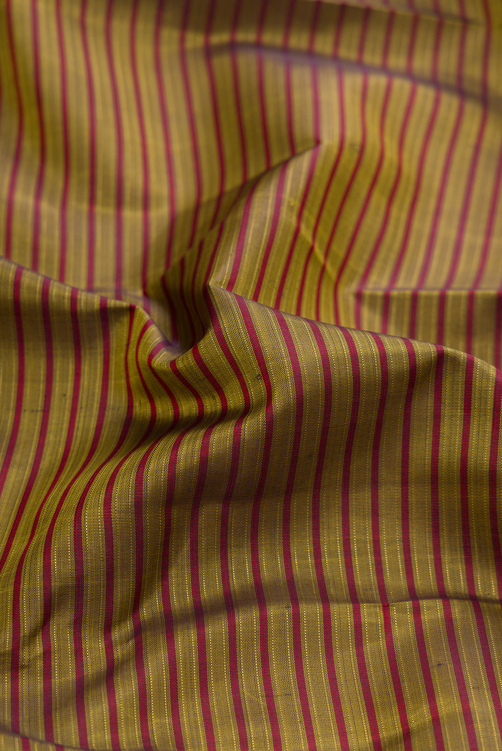 Close up of Pure Silk Pure Zari Mehandi Green Kanchipuram Saree with Stripes on the body and Plain Border.  displaying folds