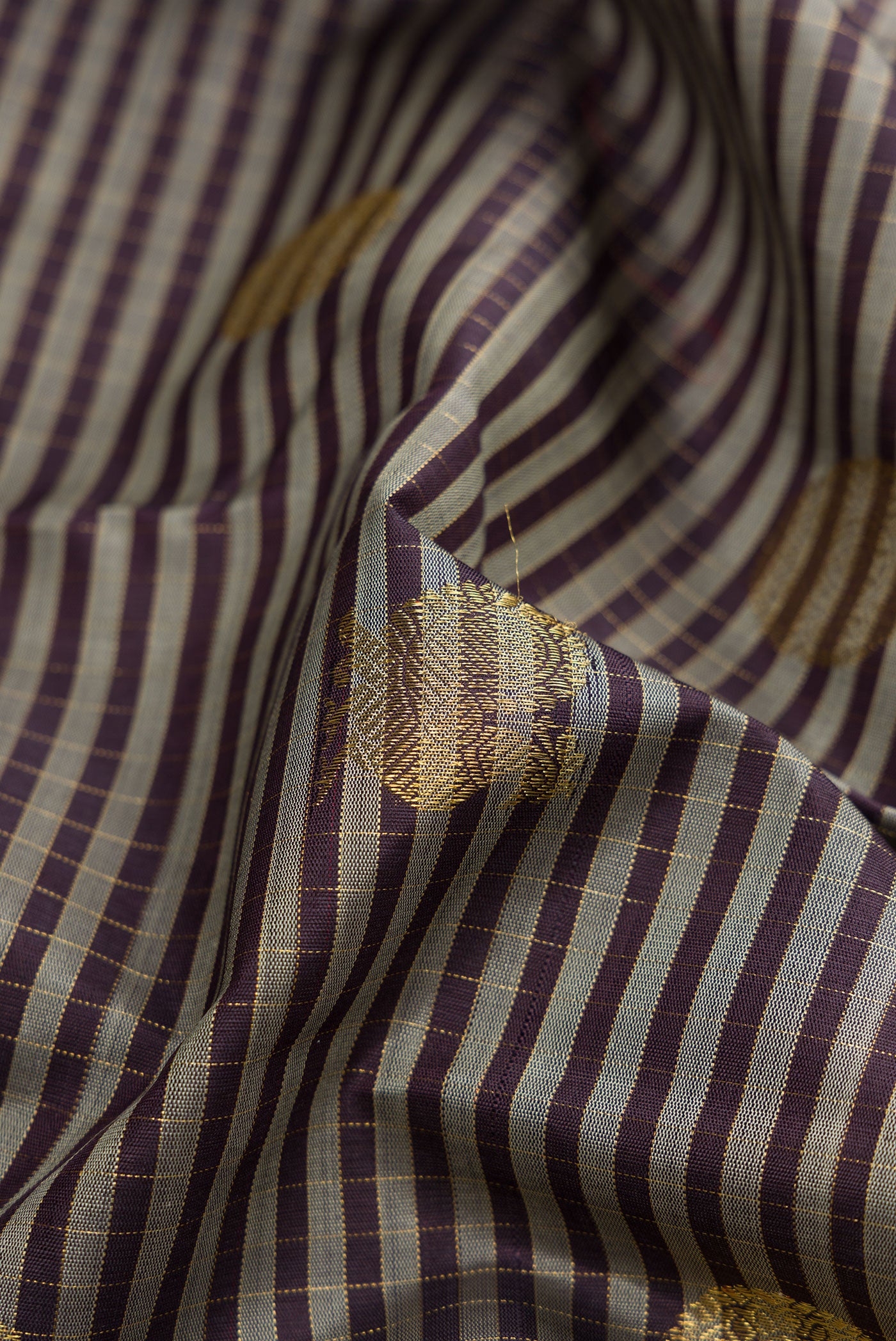 Close up of Pure Silk Pure Zari Grey Kanjivaram Saree with Checked design on the body and Zari Border.  displaying folds