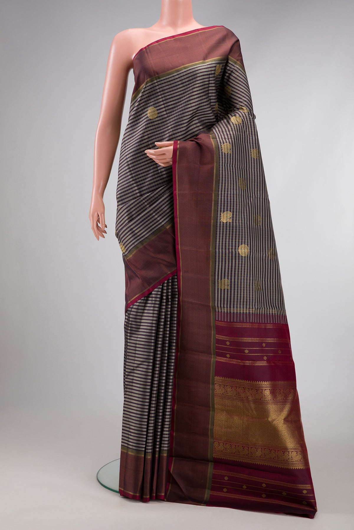 Pure Silk Pure Zari Grey Kanjivaram Saree with Checked design on the body and Zari Border.  displayed on a mannequin