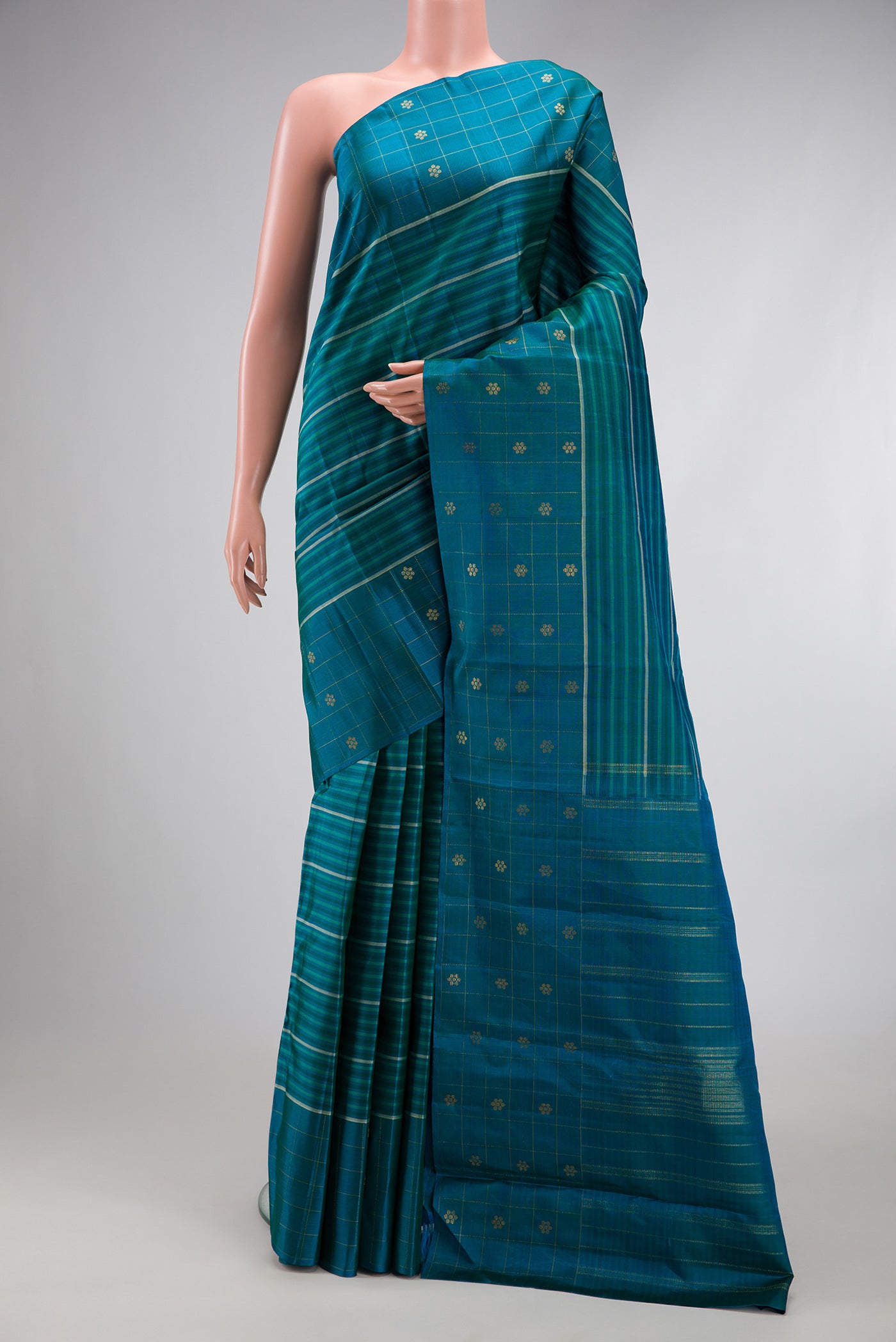 Peacock Blue Kanjivaram Silk Saree with Stripes on the body and Fancy Border.  displayed on a mannequin