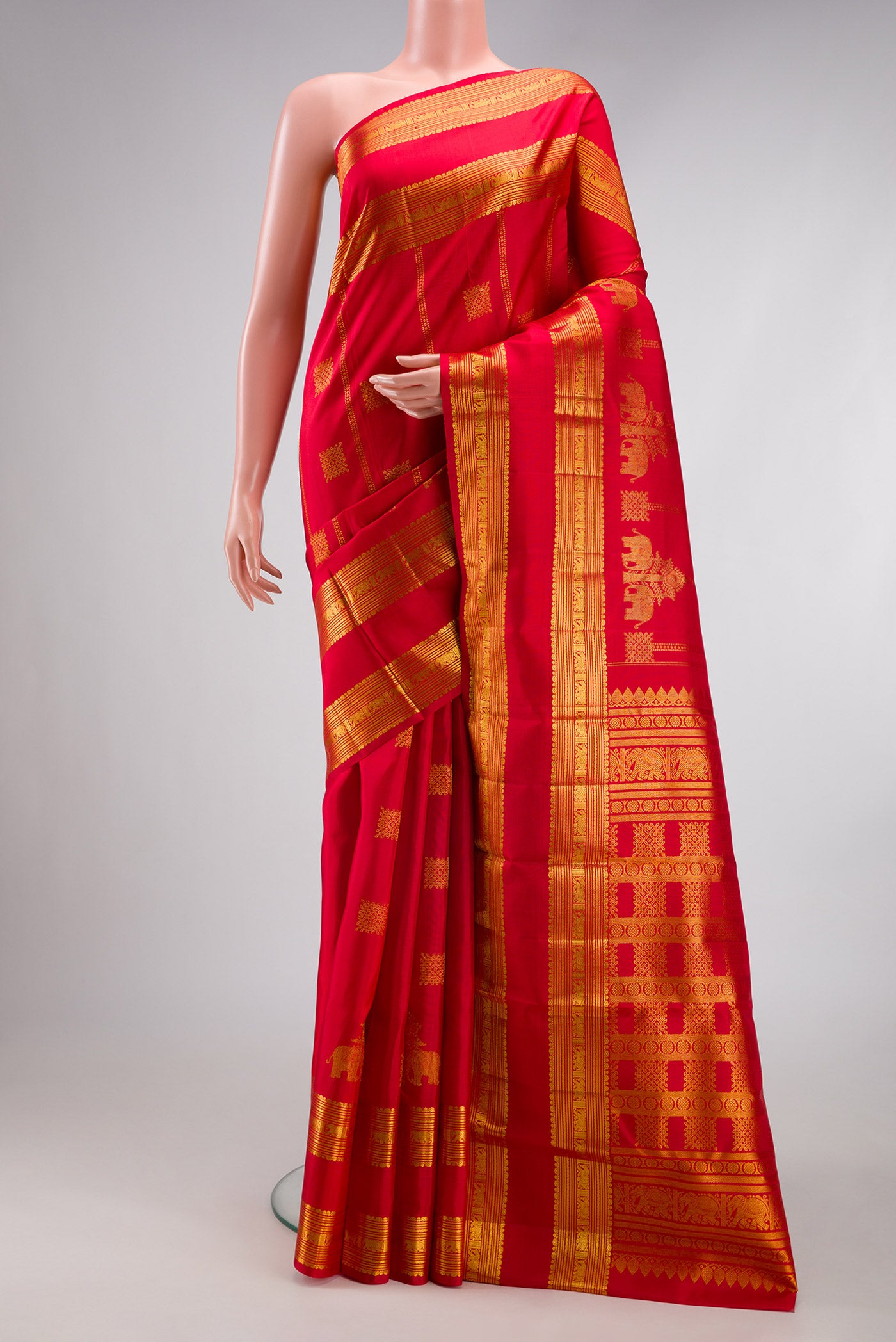 Red Kanjivaram Silk Saree with Zari Butta on the body and Zari Border.  displayed on a mannequin