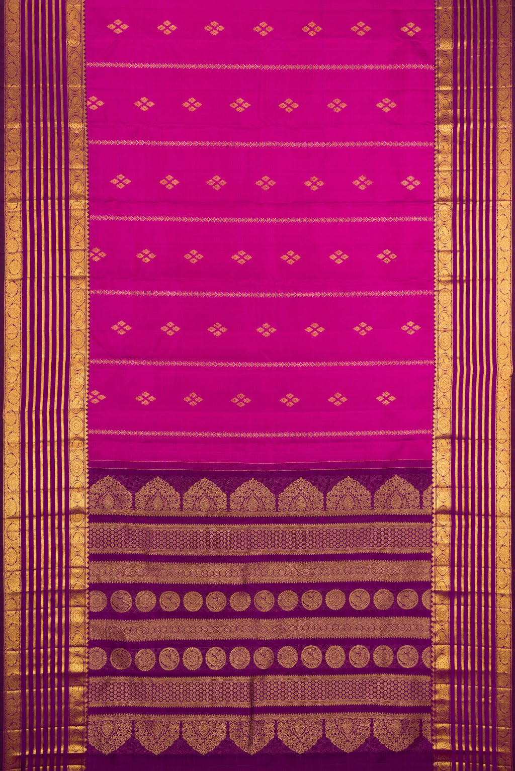 Flat view of Magenta Kanjivaram Silk Saree with Zari Butta on the body and Zari Border. 