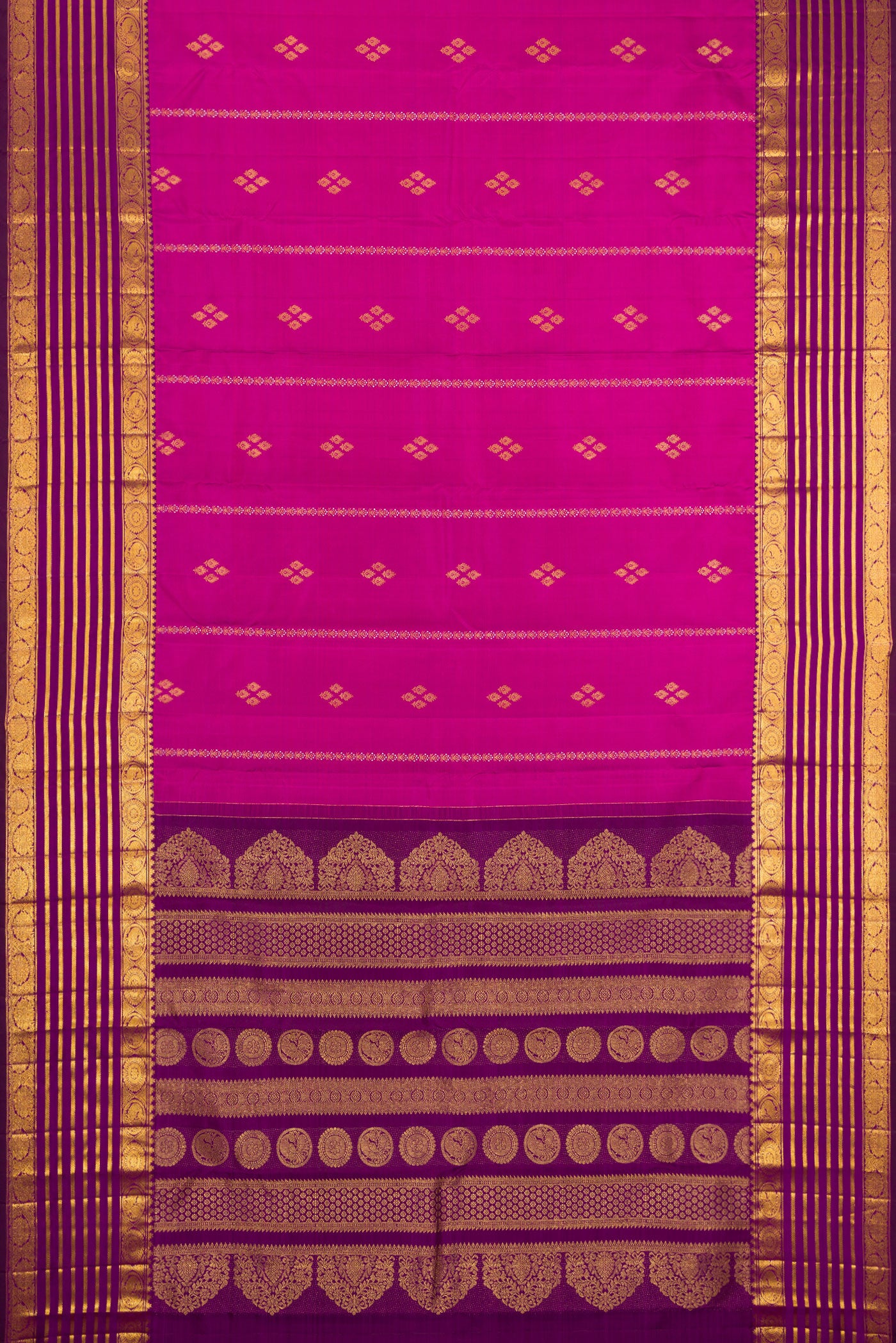 Flat view of Magenta Kanjivaram Silk Saree with Zari Butta on the body and Zari Border. 