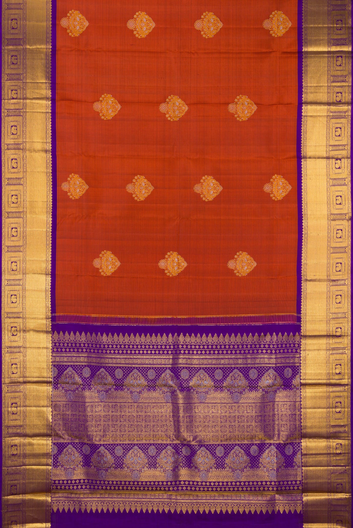 Flat view of Pure Silk Rust Kanjivaram Saree with Zari Butta on the body and Zari Border. 
