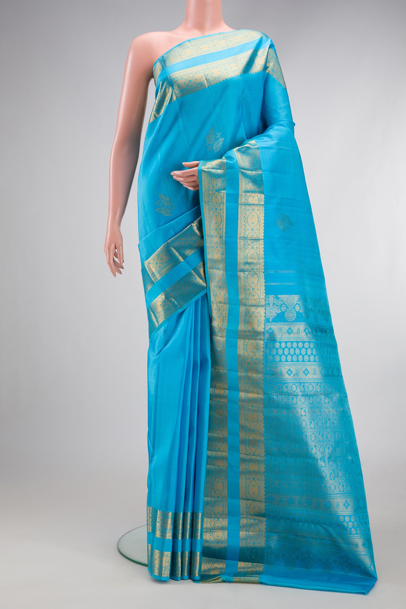 Sky Blue Kanjivaram Silk Saree with Zari Butta on the body and Zari Border.  displayed on a mannequin