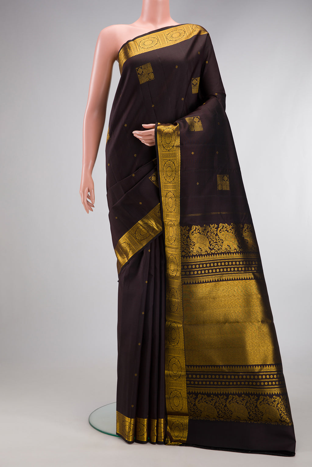 Coffee Brown Kanjivaram Silk Saree with Zari Butta on the body and Zari Border.  displayed on a mannequin
