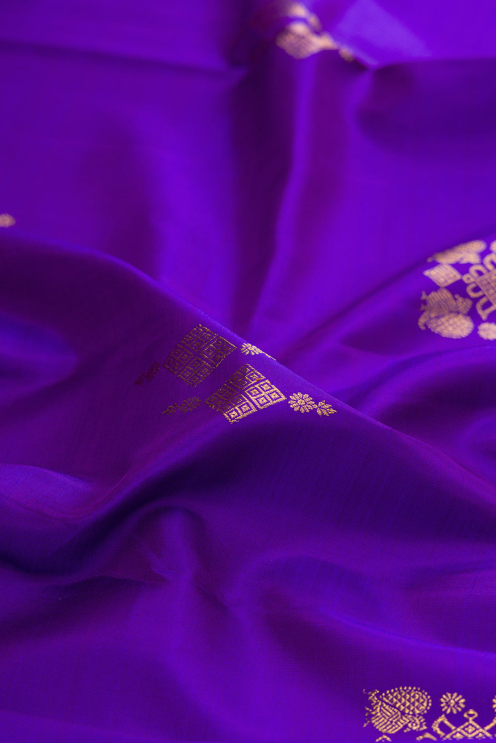 Close up of Pure Silk Violet Kanjivaram Saree with Zari Butta on the body and Zari Border.  displaying folds
