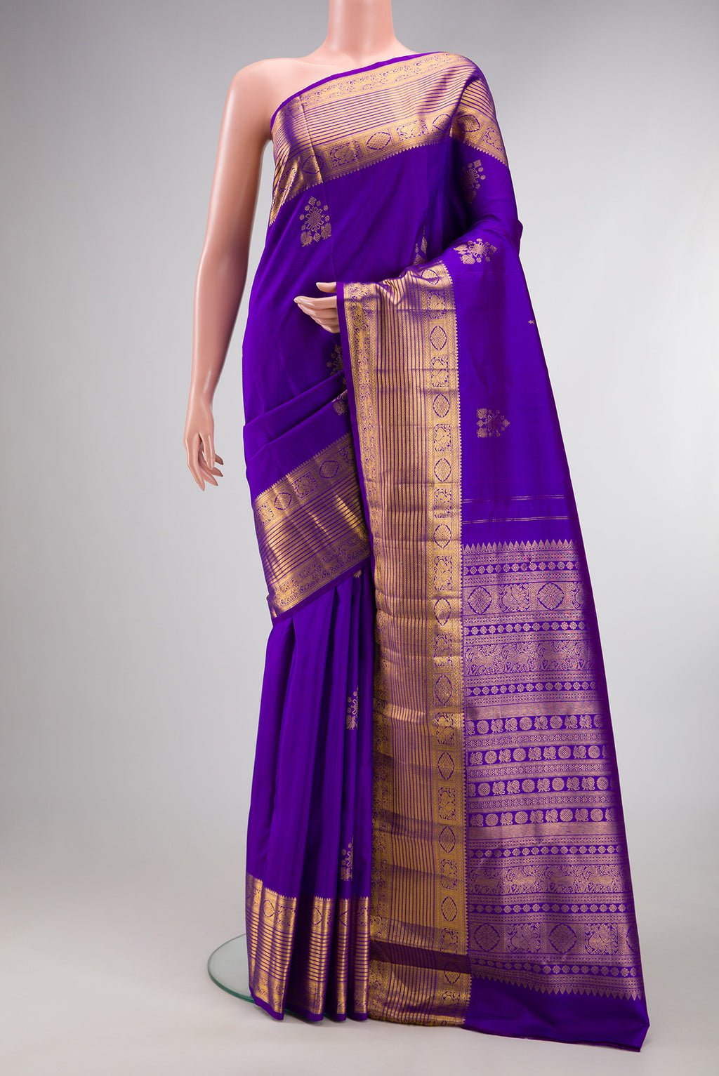 Pure Silk Violet Kanjivaram Saree with Zari Butta on the body and Zari Border.  displayed on a mannequin