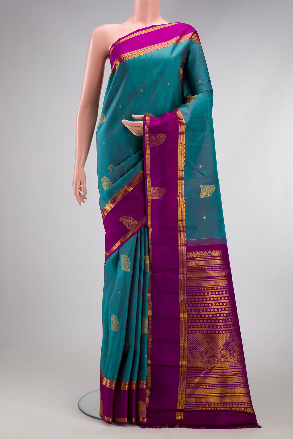 Maya Blue Dual Tone Kanjivaram Silk Saree with Zari Butta on the body and Zari Border.  displayed on a mannequin