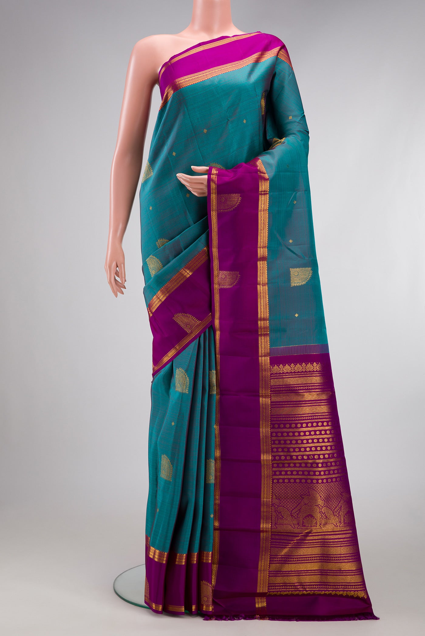 Maya Blue Dual Tone Kanjivaram Silk Saree with Zari Butta on the body and Zari Border.  displayed on a mannequin