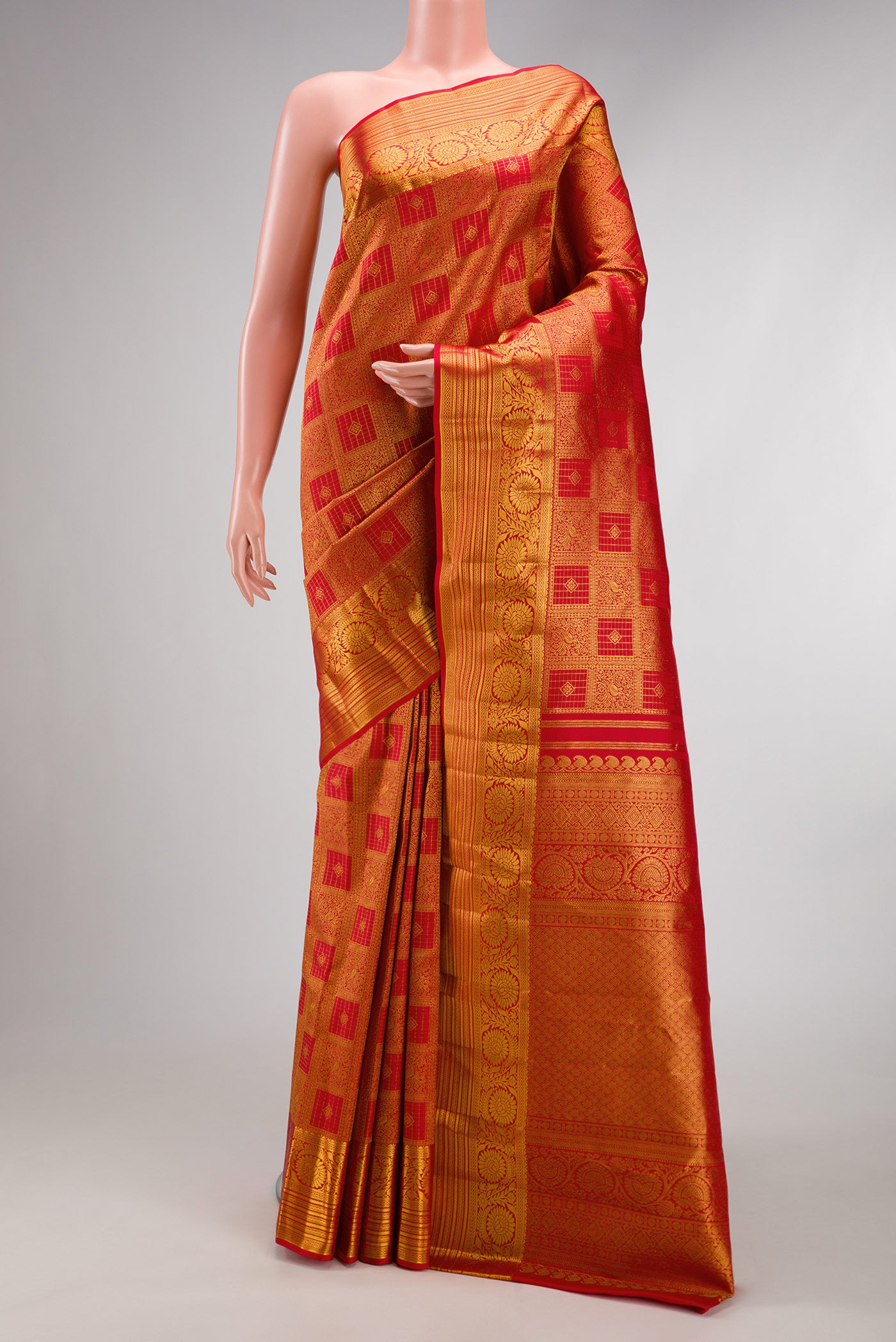 Red Kanchipuram Silk Saree with Zari Brocade on the body and Zari Border.  displayed on a mannequin