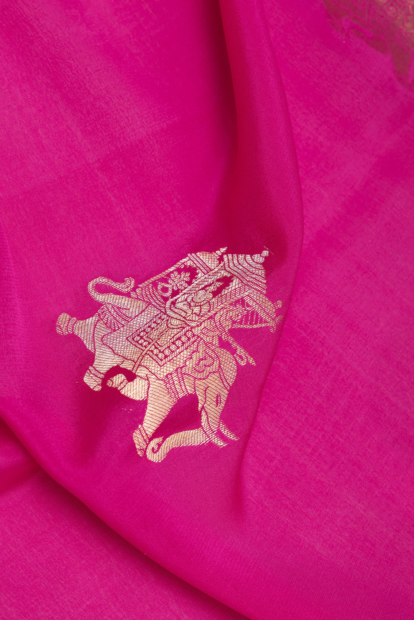 Close up of Dark Pink Mysore Silk Saree with Zari Butta on the body and Zari Border.  displaying folds