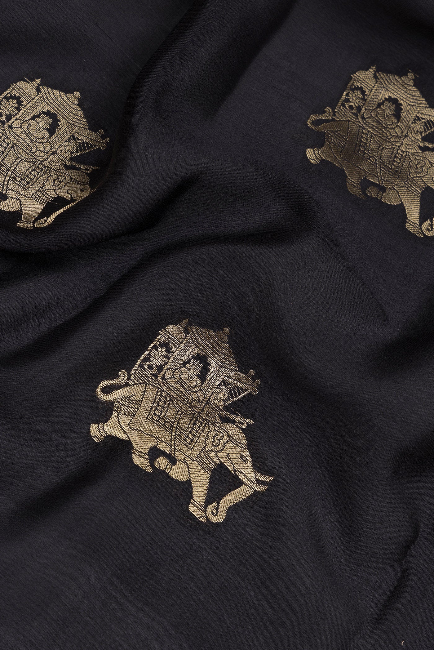 Close up of Black Mysore Silk Saree with Zari Butta on the body and Zari Border.  displaying folds