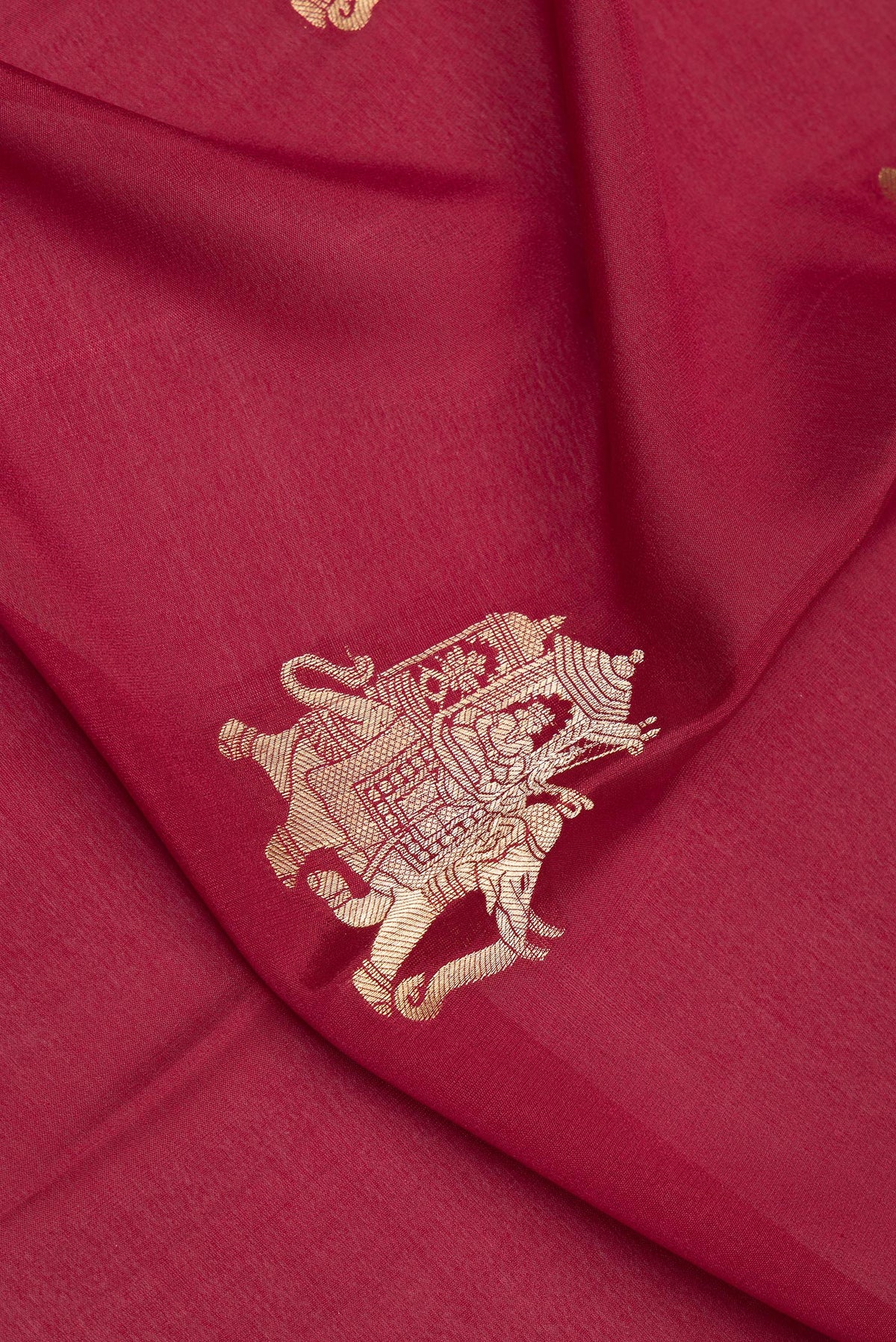 Close up of Maroon Mysore Crepe Saree with Zari Butta on the body and Zari Border.  displaying folds