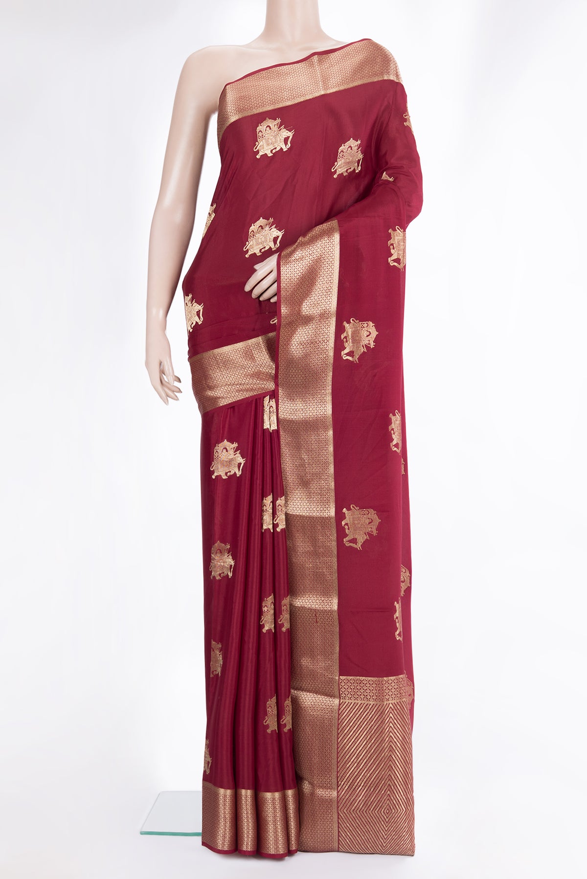 Maroon Mysore Crepe Saree with Zari Butta on the body and Zari Border.  displayed on a mannequin
