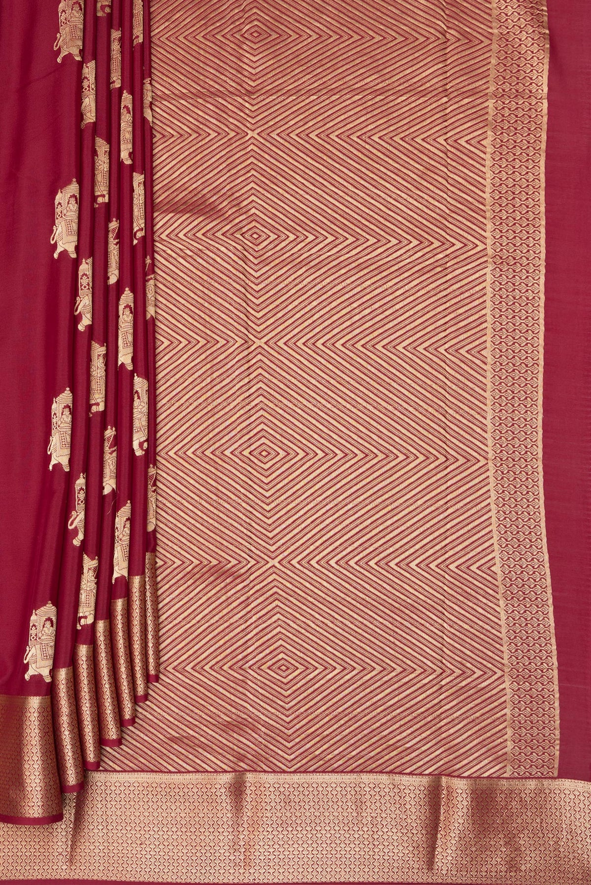 Pleats and pallu of Maroon Mysore Crepe Saree with Zari Butta on the body and Zari Border. 