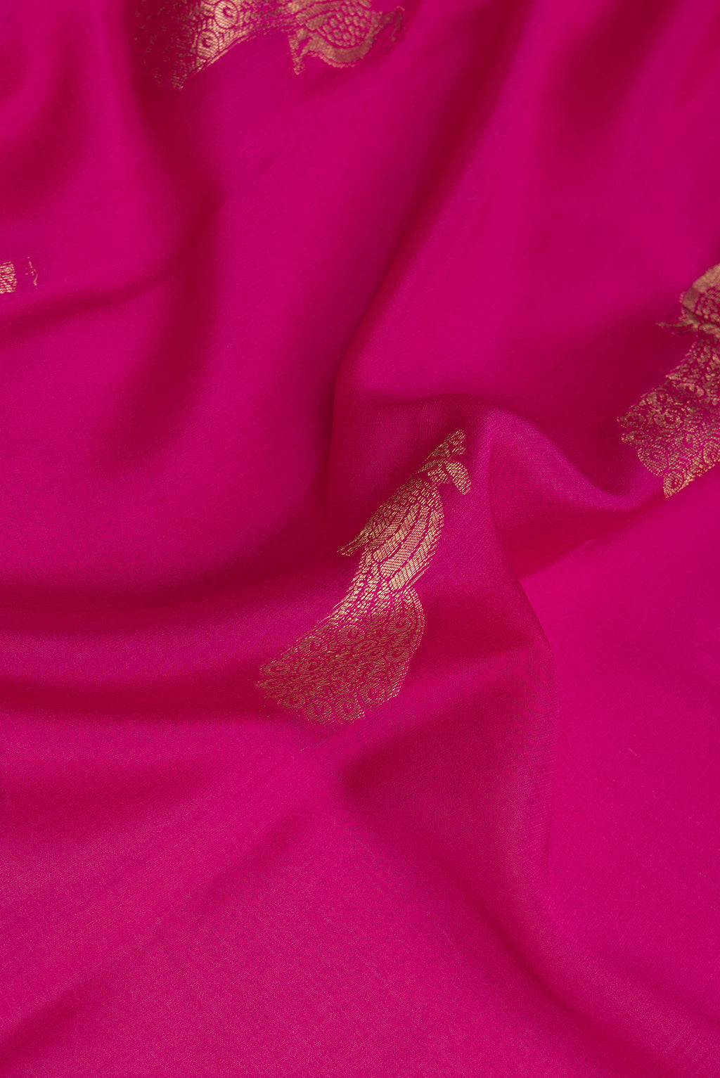Close up of Dark Pink Mysore Crepe Saree with Zari Butta on the body and Fancy Border.  displaying folds