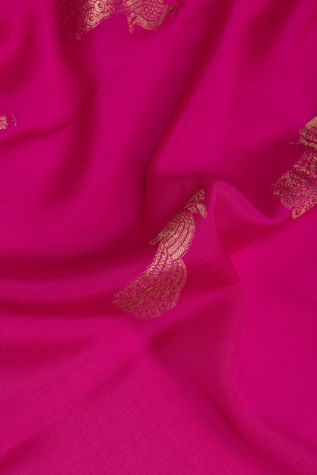 Close up of Dark Pink Mysore Crepe Saree with Zari Butta on the body and Fancy Border.  displaying folds