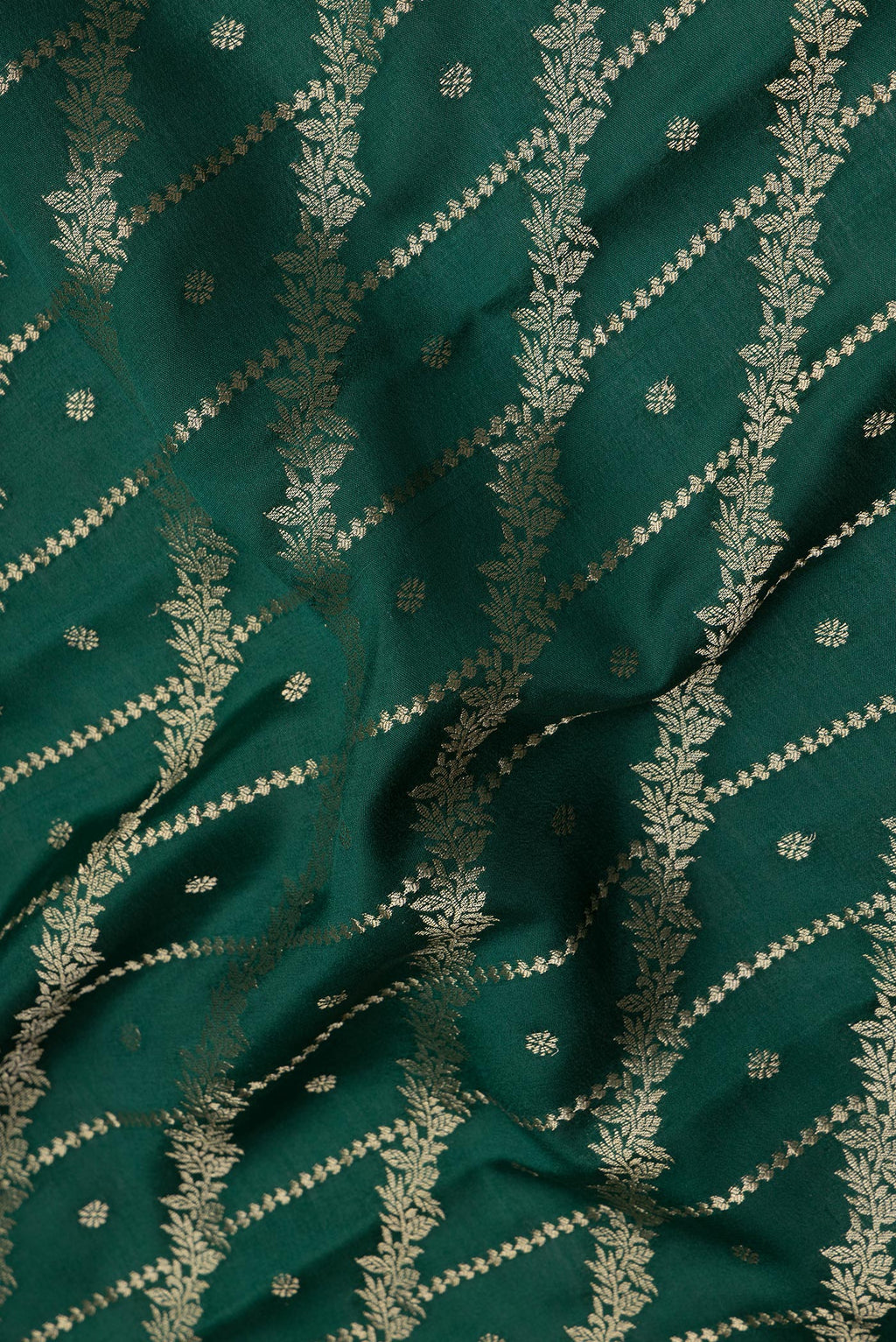 Close up of Bottle Green Crepe Saree with Zari Brocade on the body and Zari Border.  displaying folds