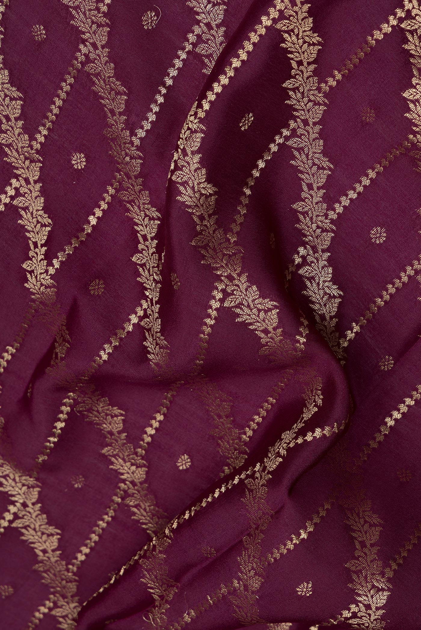 Close up of Burgundy Mysore Silk Saree with Zari Brocade on the body and Zari Border.  displaying folds