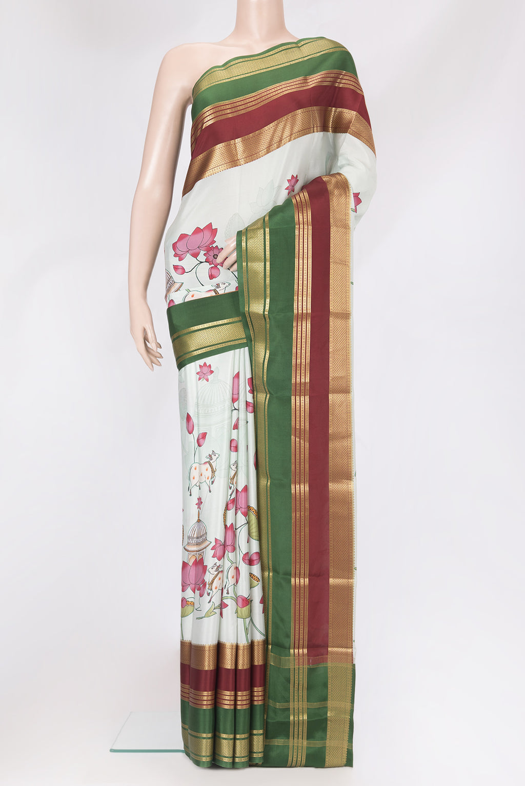 Pista Green Mysore Silk Saree with Printed design on the body and Zari Border.  displayed on a mannequin