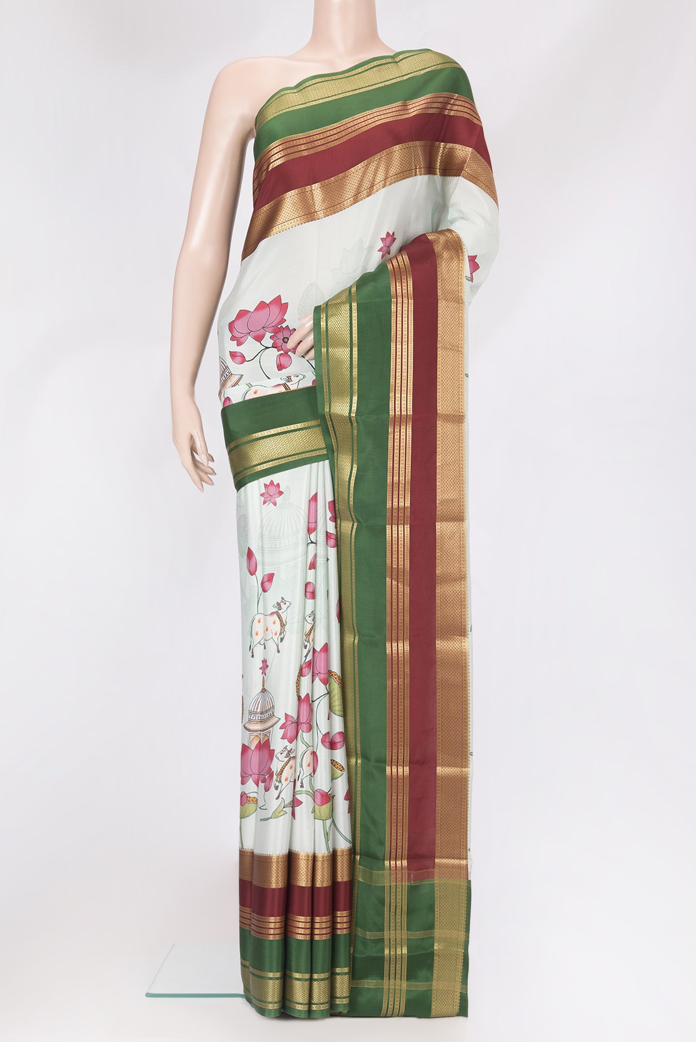 Pista Green Mysore Silk Saree with Printed design on the body and Zari Border.  displayed on a mannequin