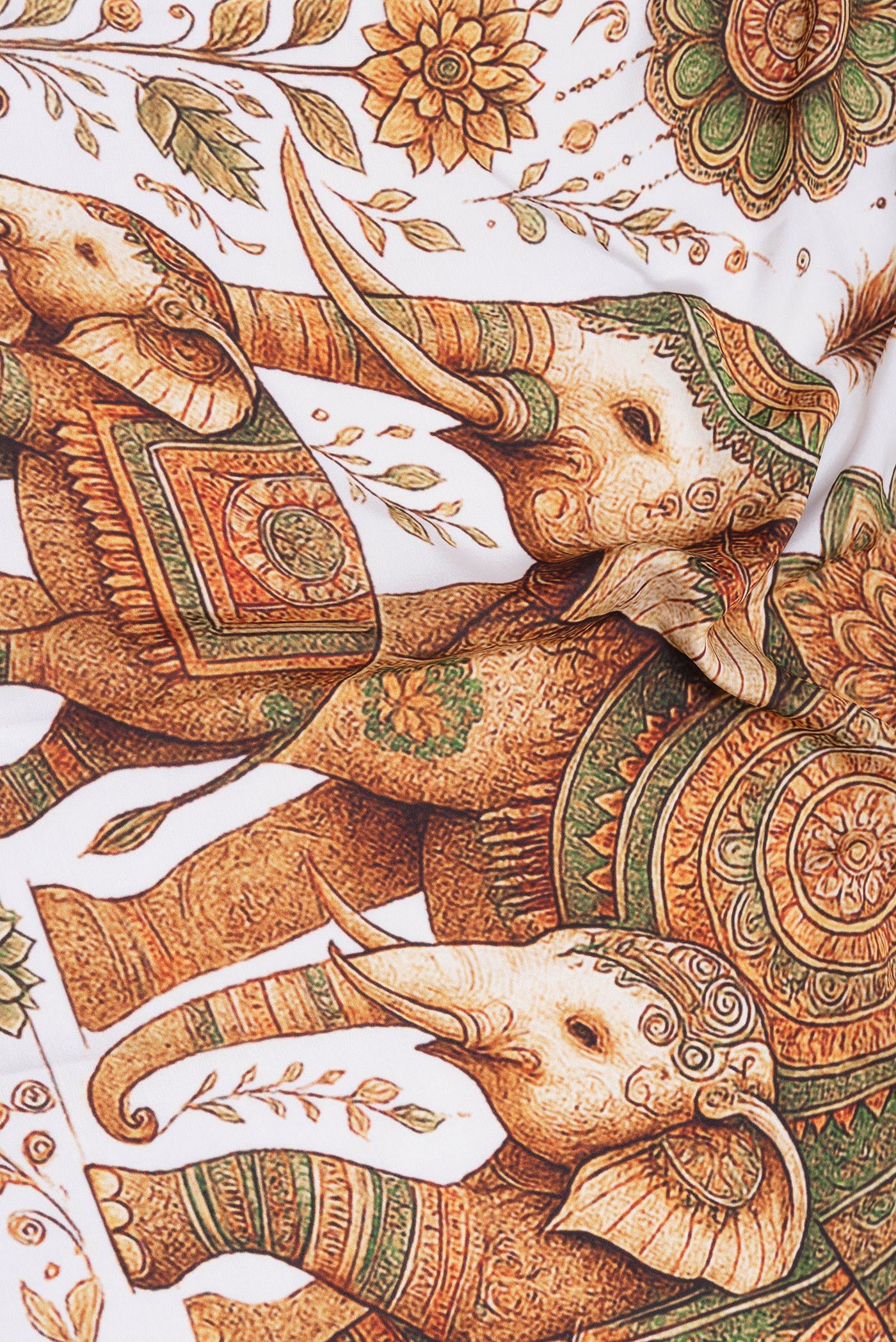 Close up of Off White Mysore Silk Saree with Printed design on the body and Fancy Border.  displaying folds