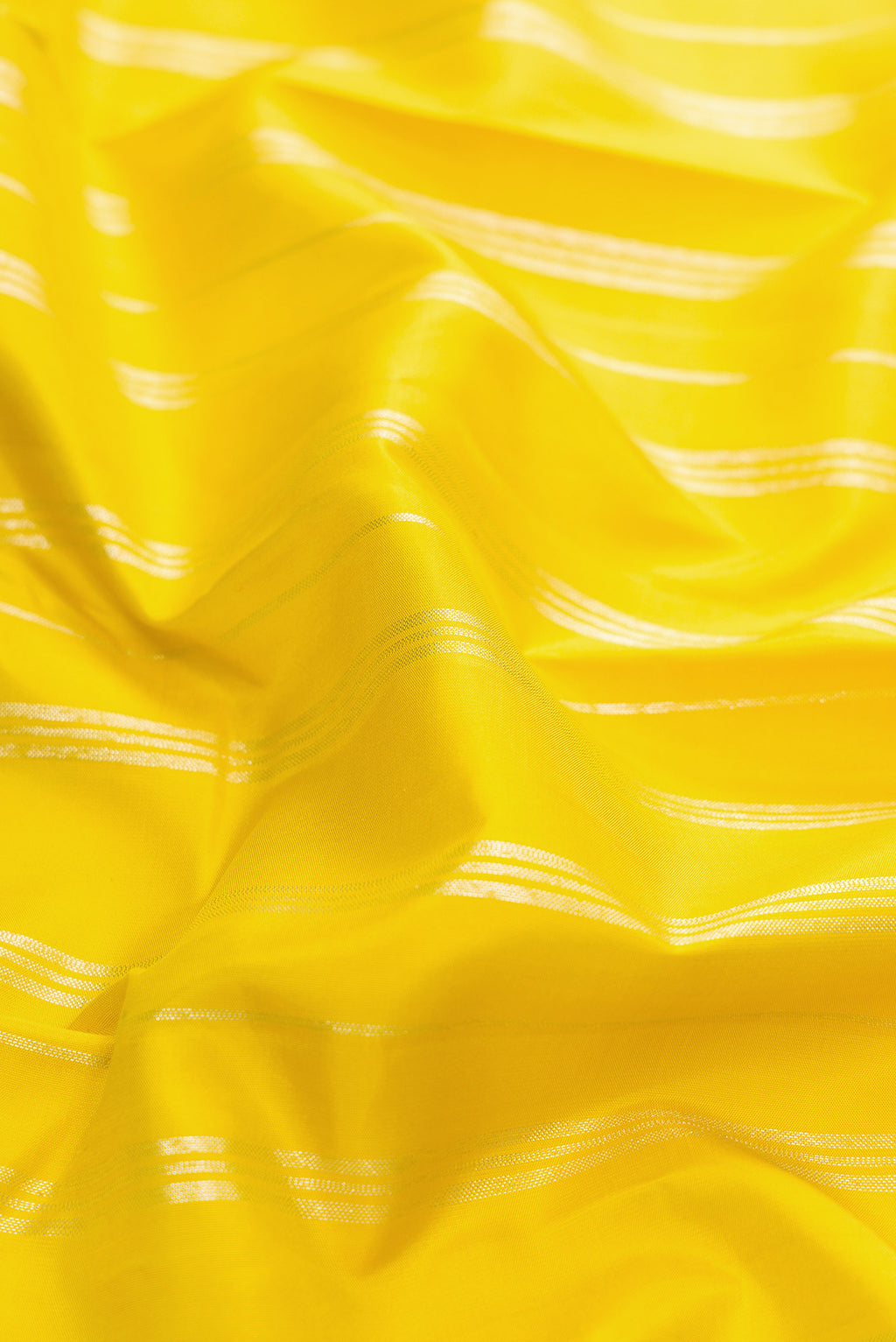 Close up of Lemon Yellow Kanjivaram Silk Saree with Stripes on the body and Without Border.  displaying folds