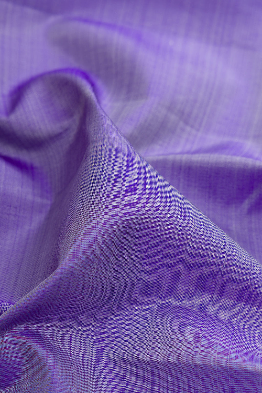 Close up of Violet Kanchipuram Silk Saree with Plain Body and Temple Border.  displaying folds