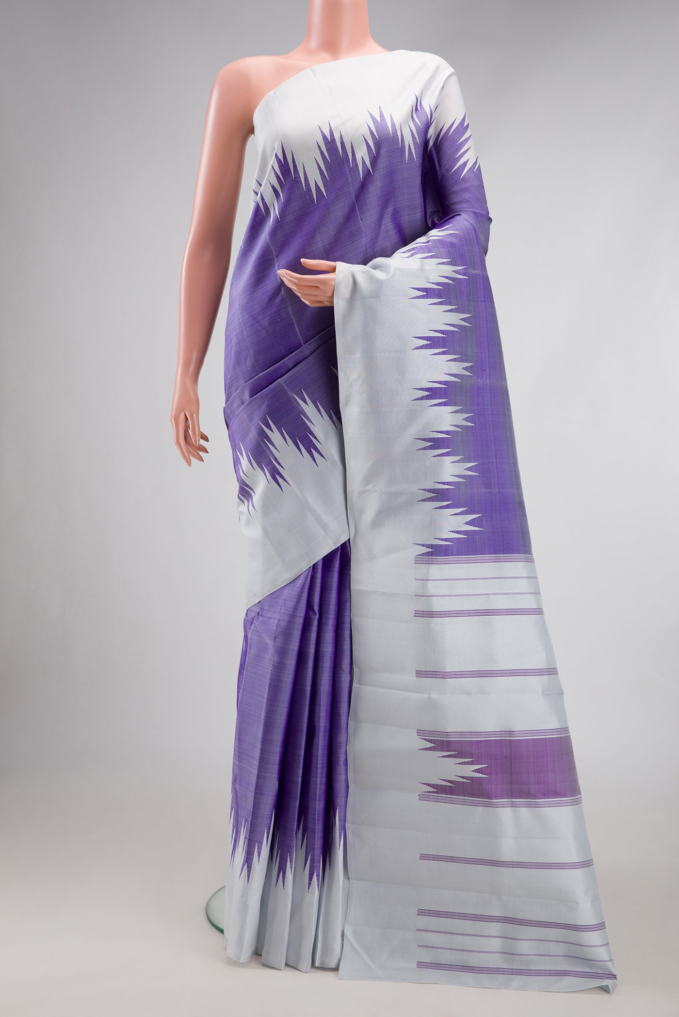 Violet Kanchipuram Silk Saree with Plain Body and Temple Border.  displayed on a mannequin