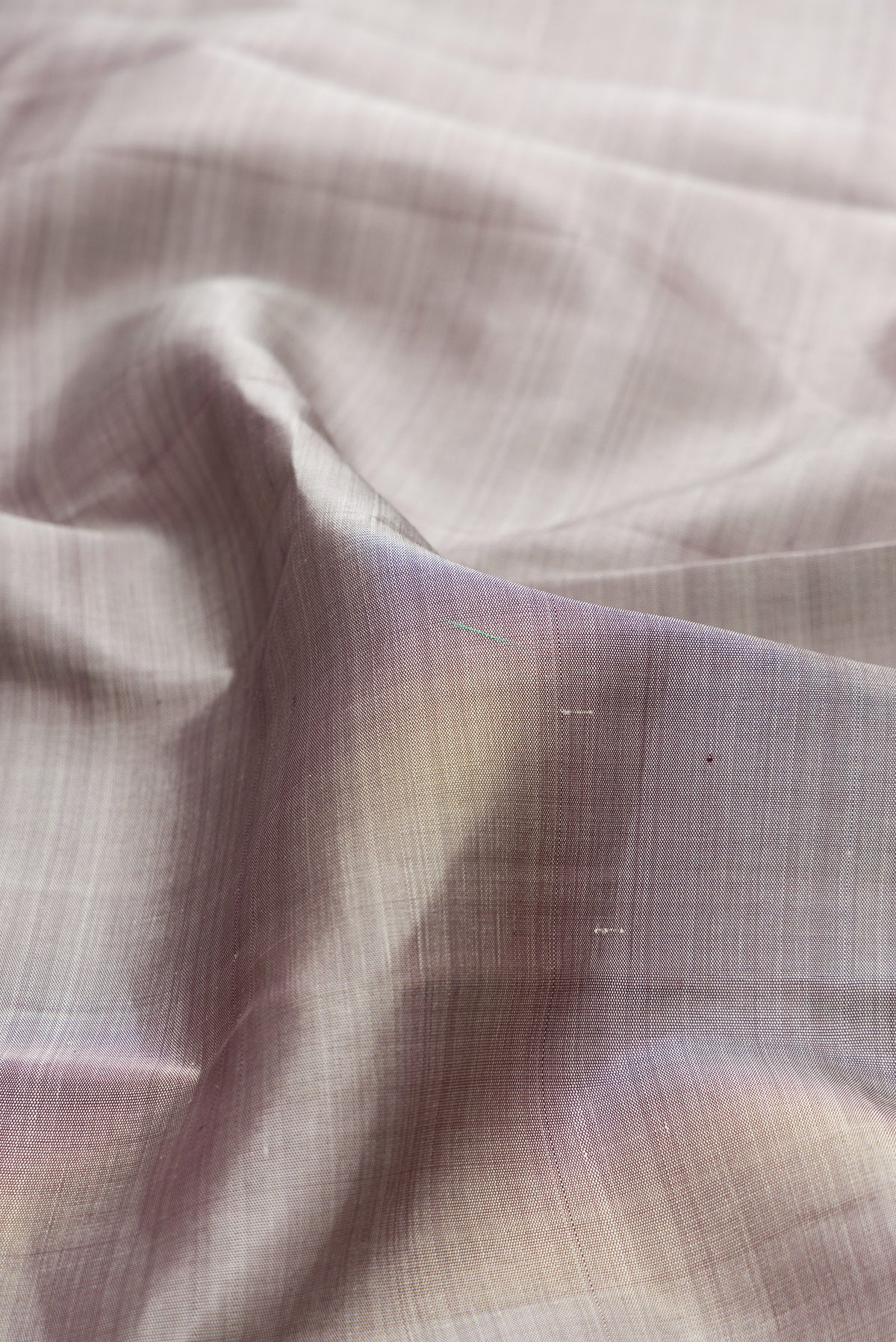 Close up of Pure Silk Grey Kanchipuram Saree with Plain Body and Rising Temple Border.  displaying folds
