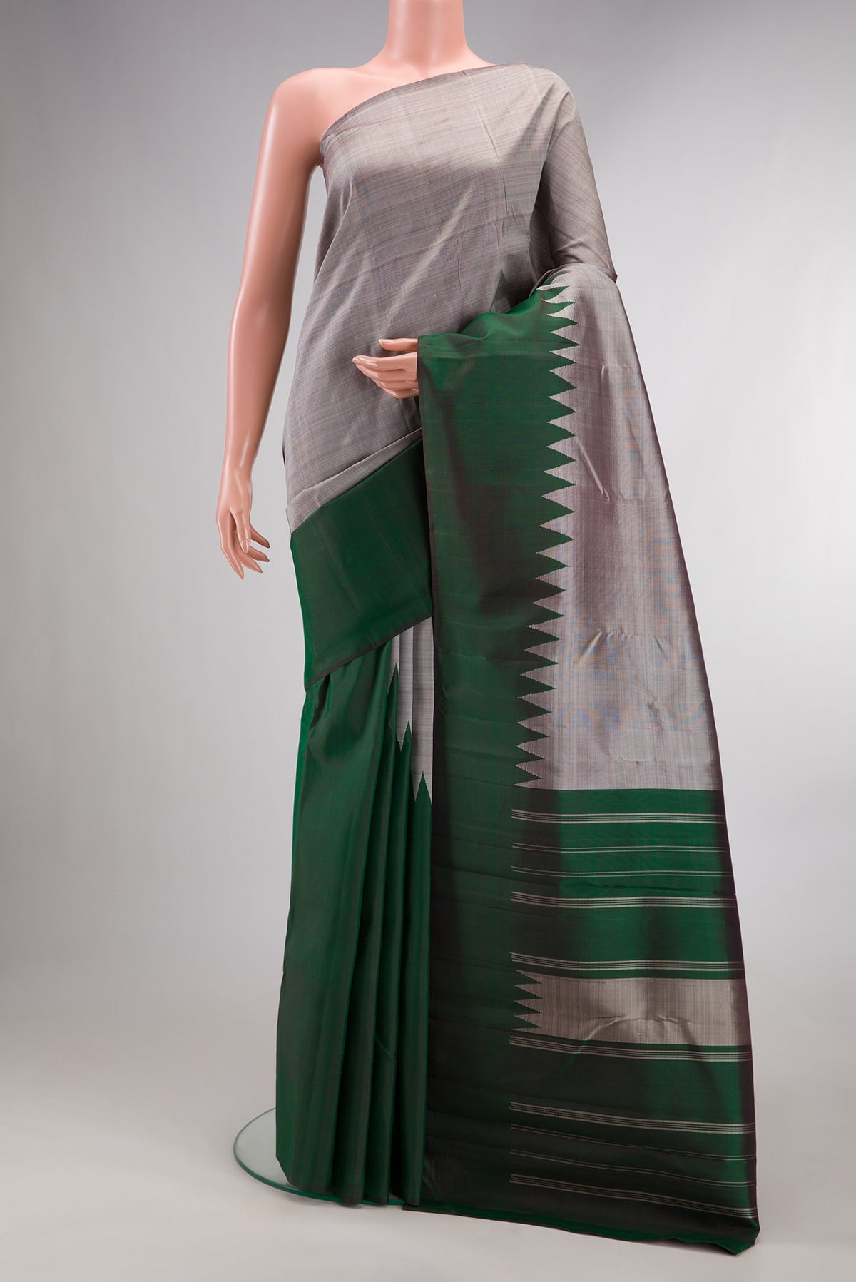 Pure Silk Grey Kanchipuram Saree with Plain Body and Rising Temple Border.  displayed on a mannequin