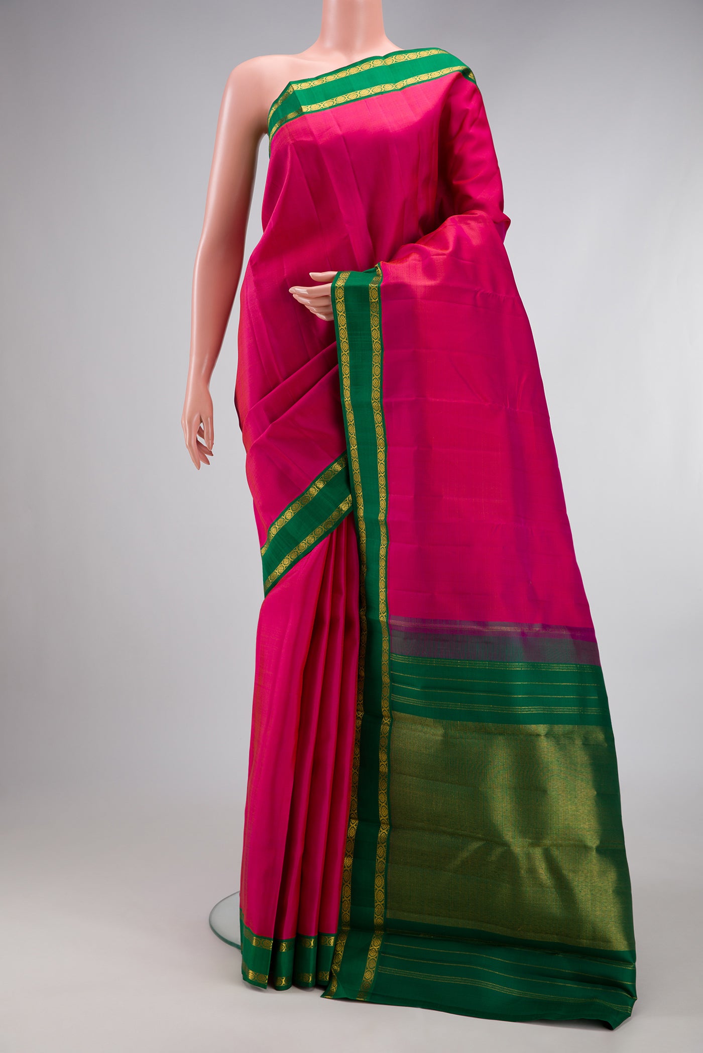 Pink Kanjivaram Silk Saree with Plain Body and Zari Border.  displayed on a mannequin