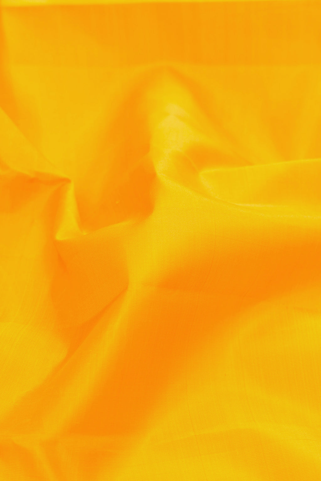 Close up of Pure Silk Pure Zari Yellow Kanjivaram Saree with Plain Body and Zari Border.  displaying folds