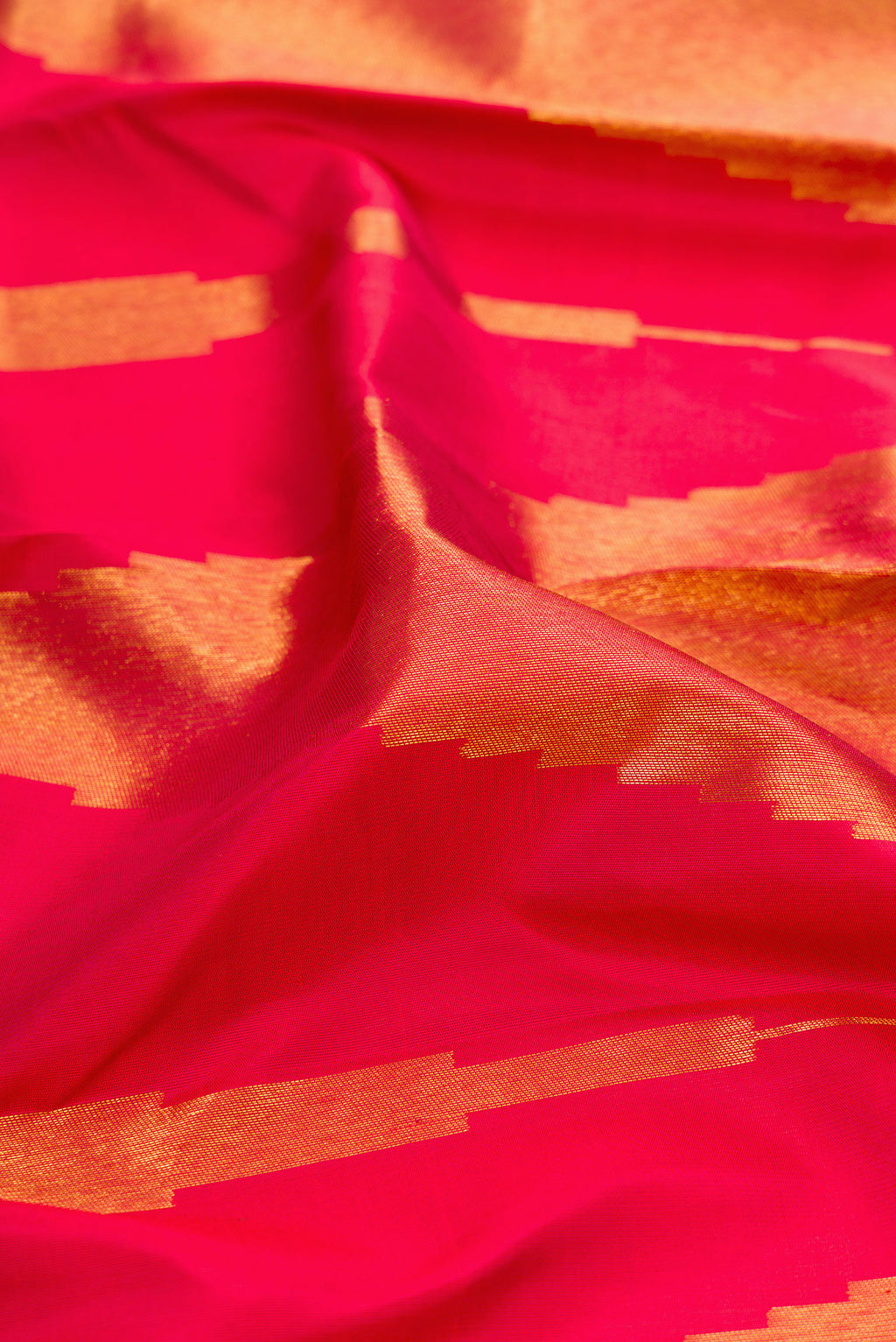 Close up of Maroon Kanjivaram Silk Saree with Zari Butta on the body and Without Border.  displaying folds