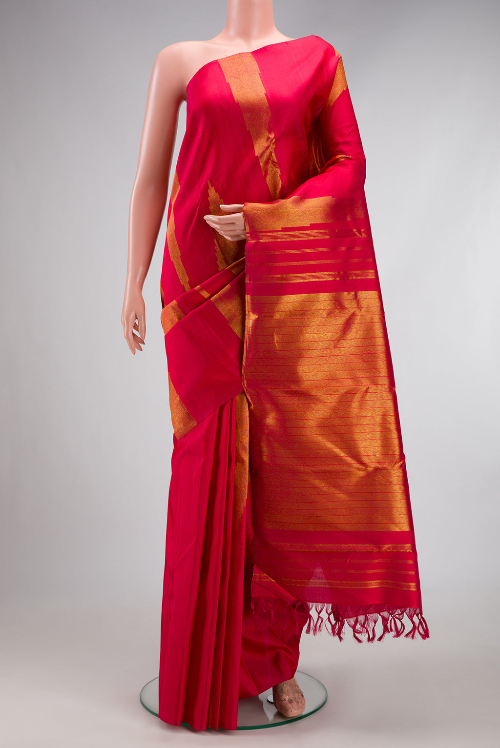 Maroon Kanjivaram Silk Saree with Zari Butta on the body and Without Border.  displayed on a mannequin
