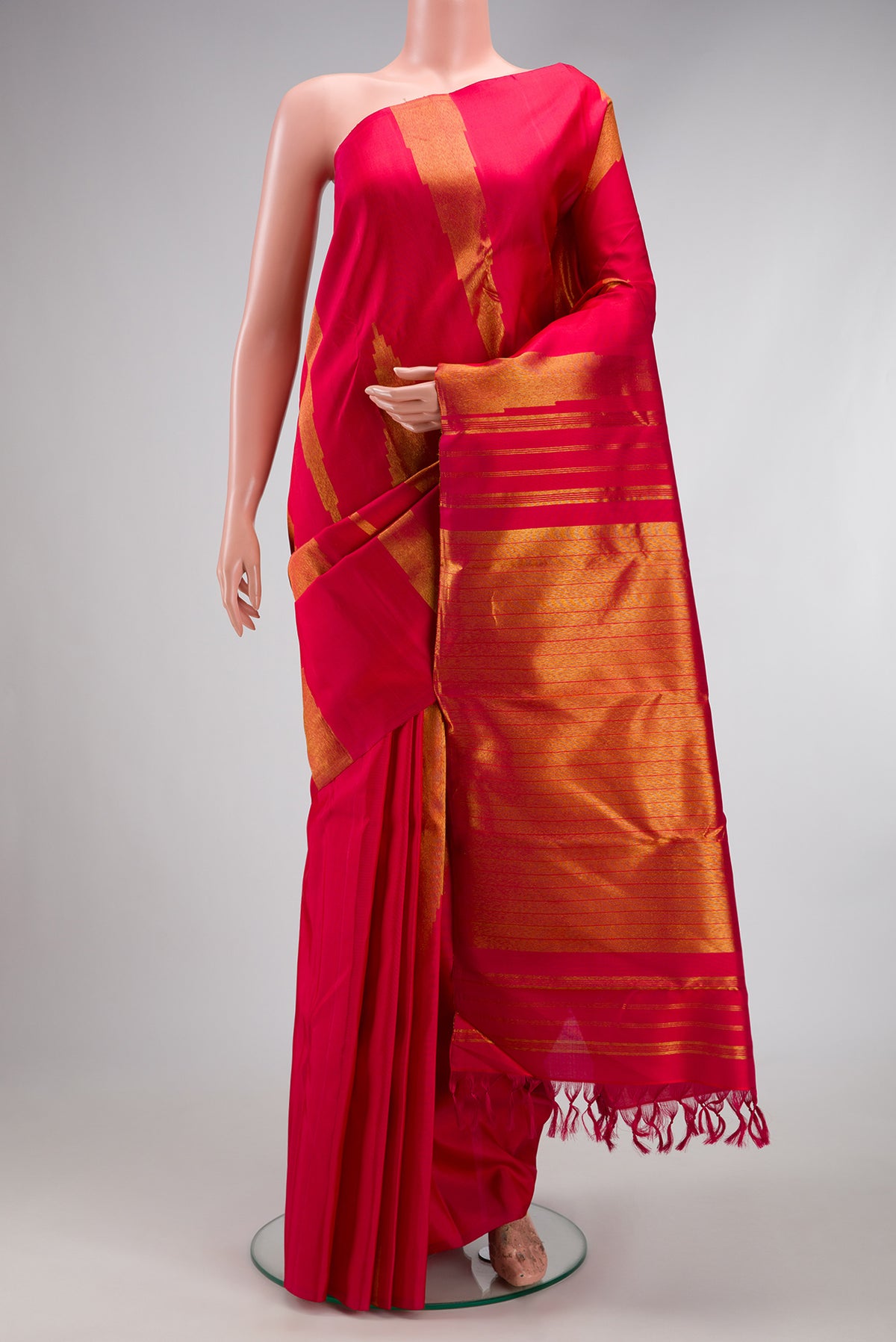 Maroon Kanjivaram Silk Saree with Zari Butta on the body and Without Border.  displayed on a mannequin