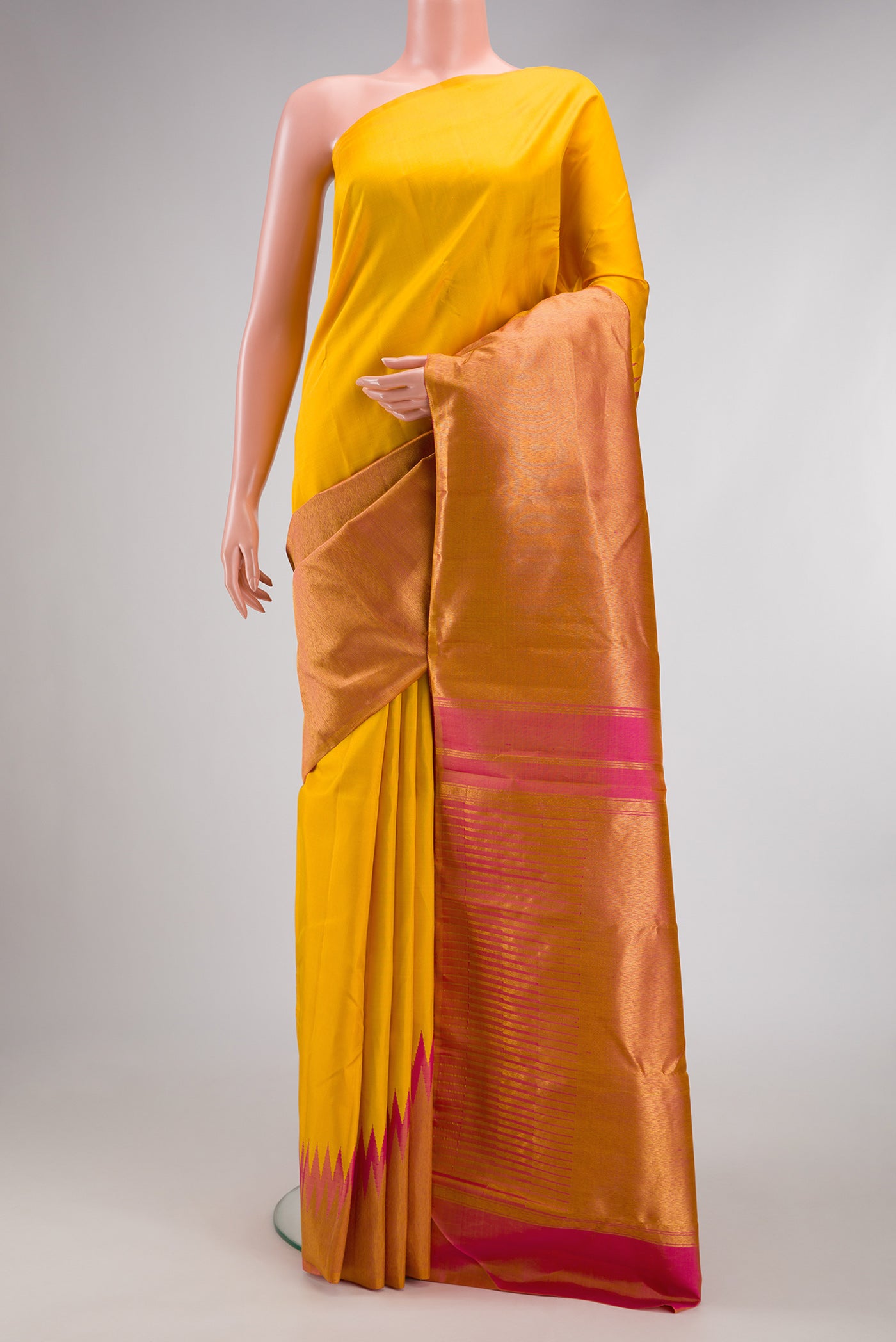 Yellow Kanjivaram Silk Saree with Plain Body and Rising Temple Border.  displayed on a mannequin