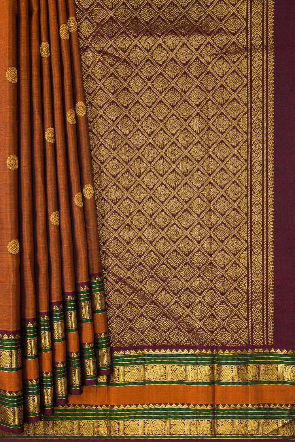 Pleats and pallu of Rust Kanjivaram Silk Saree with Zari Butta on the body and Zari Border. 