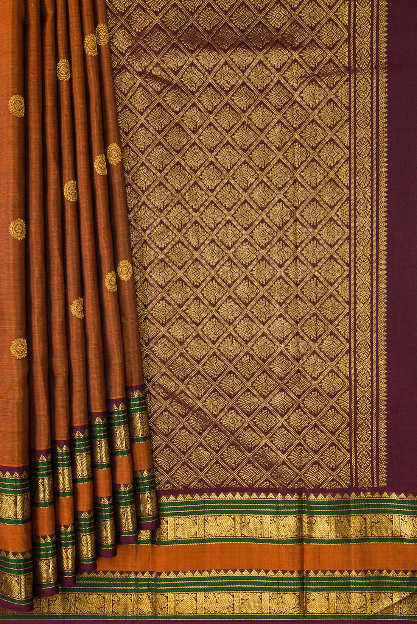 Pleats and pallu of Rust Kanjivaram Silk Saree with Zari Butta on the body and Zari Border. 