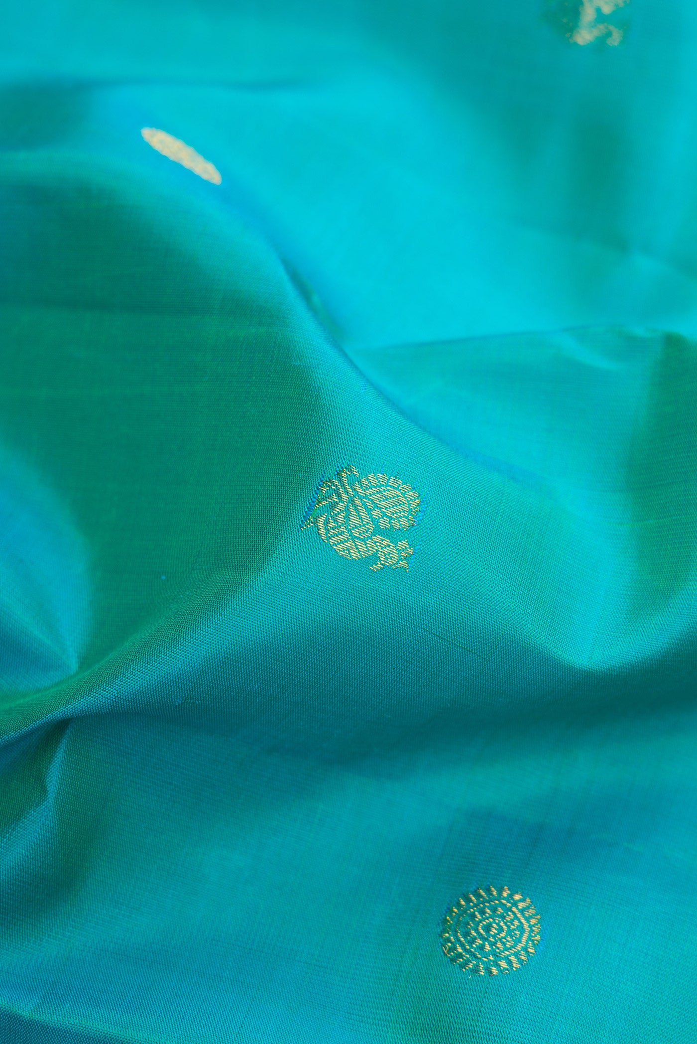 Close up of Blue Kanjivaram Silk Saree with Zari Butta on the body and Zari Border.  displaying folds