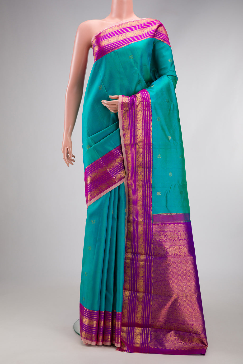 Blue Kanjivaram Silk Saree with Zari Butta on the body and Zari Border.  displayed on a mannequin