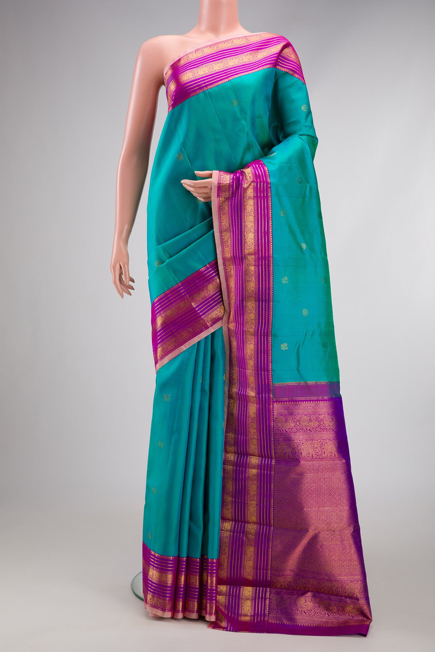 Blue Kanjivaram Silk Saree with Zari Butta on the body and Zari Border.  displayed on a mannequin