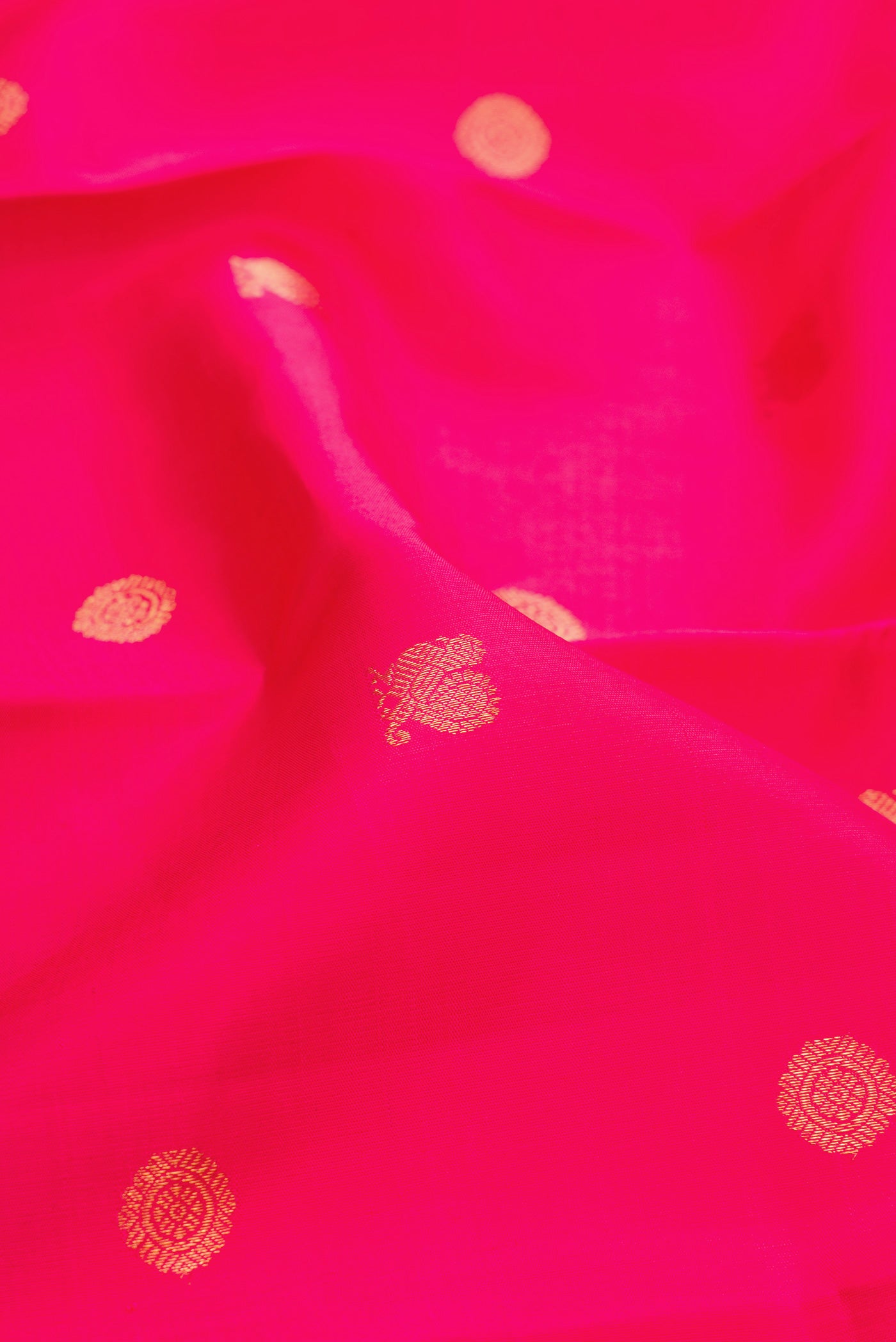 Close up of Pink Kanjivaram Silk Saree with Zari Butta on the body and Zari Border.  displaying folds